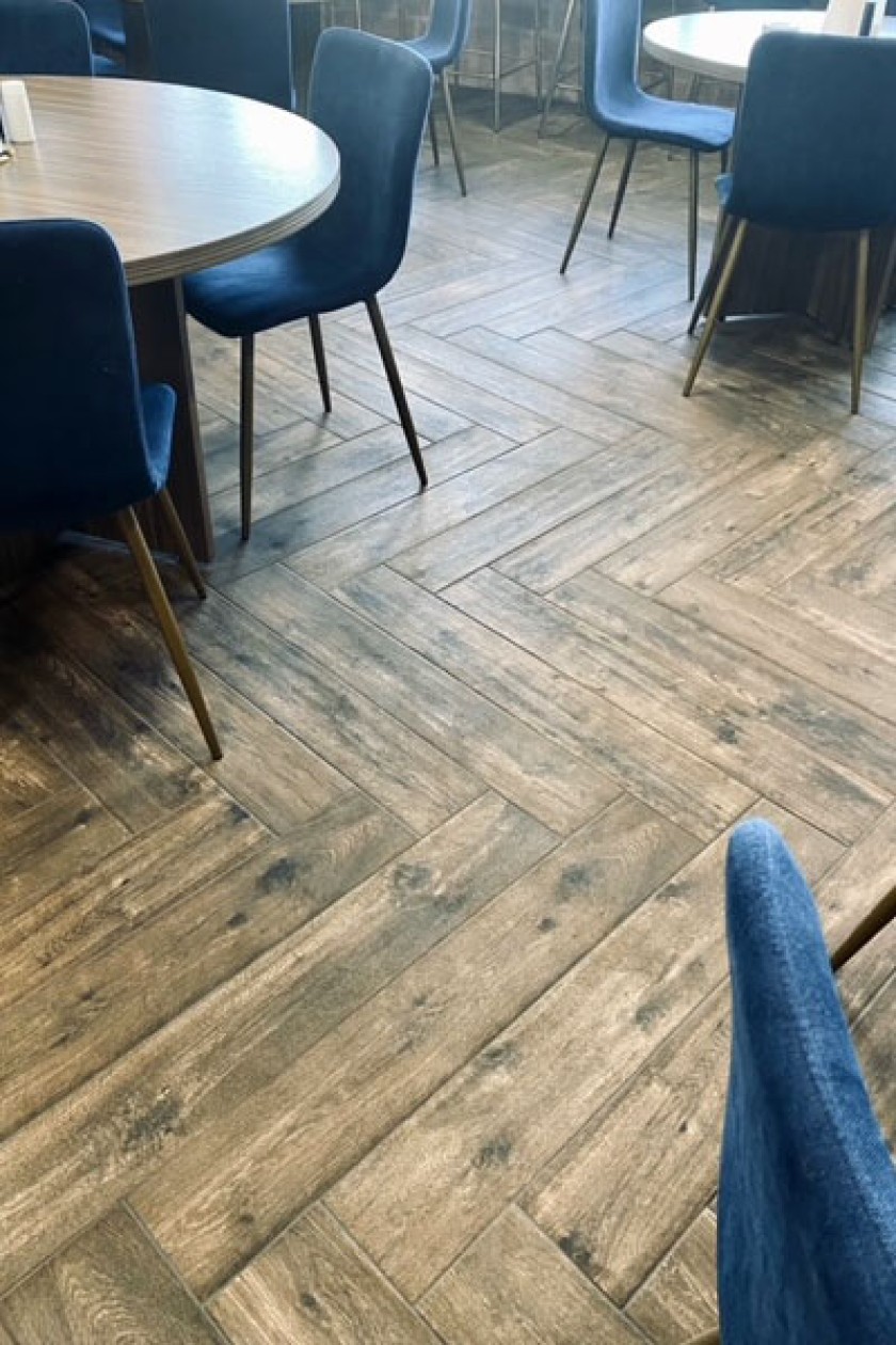 Brown wooden plank flooring with a unique design.