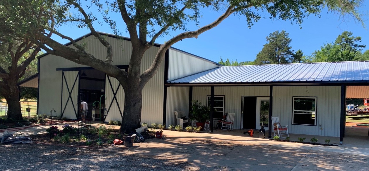 White bardominium house with black detailing in the country.