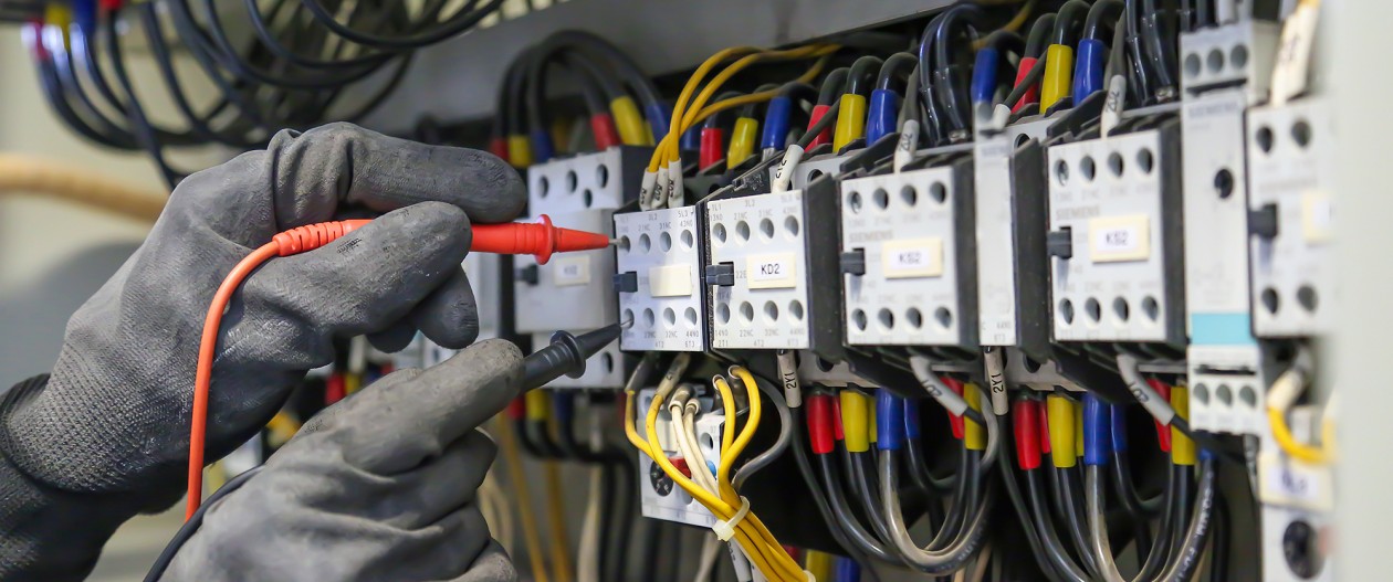 Individual doing electrical work.